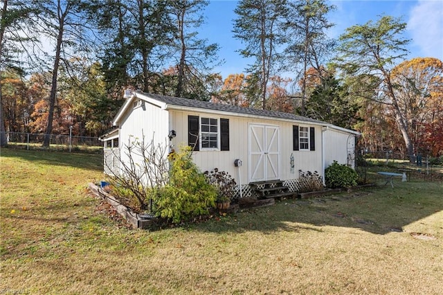 view of outdoor structure featuring a lawn