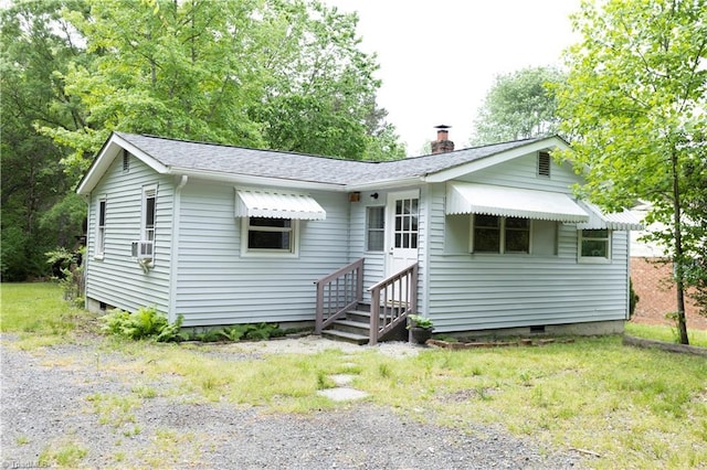 rear view of house with a chimney and crawl space