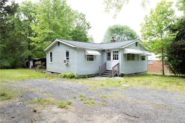 view of front of home with crawl space, cooling unit, a chimney, and roof with shingles