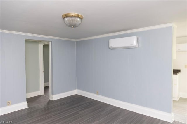 spare room with baseboards, dark wood-style floors, and a wall unit AC