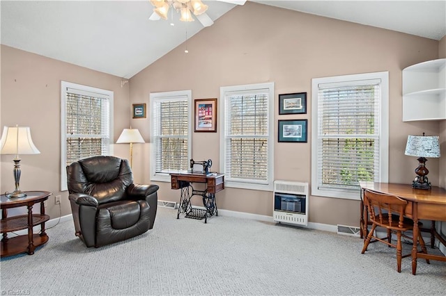 sitting room with heating unit, visible vents, carpet flooring, and lofted ceiling