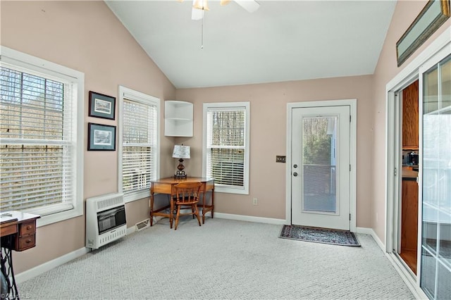 doorway to outside featuring heating unit, plenty of natural light, carpet flooring, and lofted ceiling