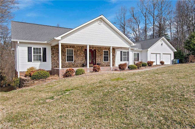 view of front of home with stone siding, a front lawn, an attached garage, and a shingled roof