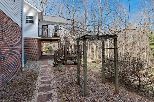 view of yard featuring stairs, cooling unit, and a wooden deck