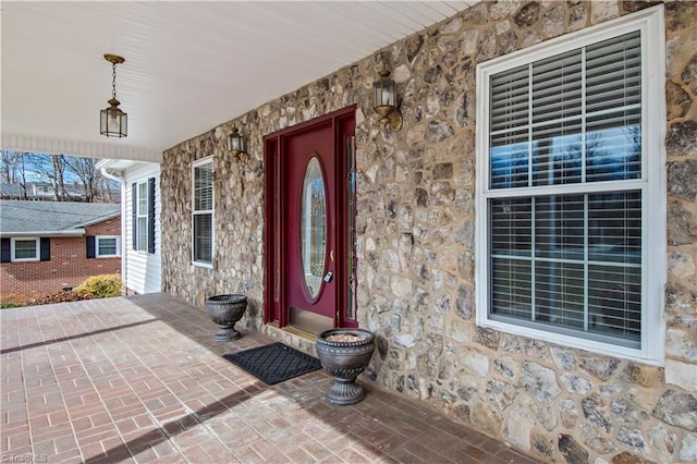 doorway to property featuring stone siding