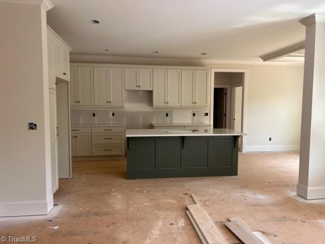 184 Providence Trl, Madison, NC 27025 - kitchen with a kitchen island, white cabinetry, baseboards, and crown molding