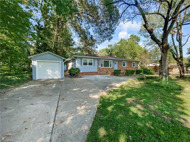 single story home with a garage, a front lawn, and an outbuilding