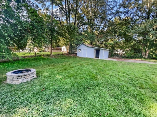 view of yard with a fire pit and a shed