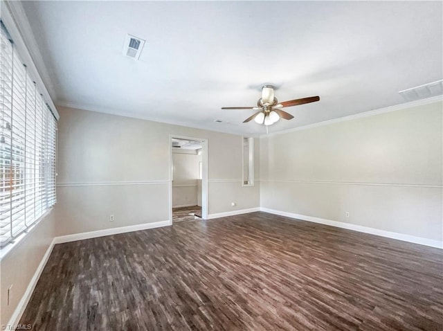 spare room featuring crown molding, dark wood-type flooring, and ceiling fan