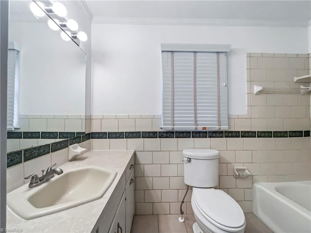 bathroom with vanity, a bathing tub, tile walls, toilet, and tile patterned floors