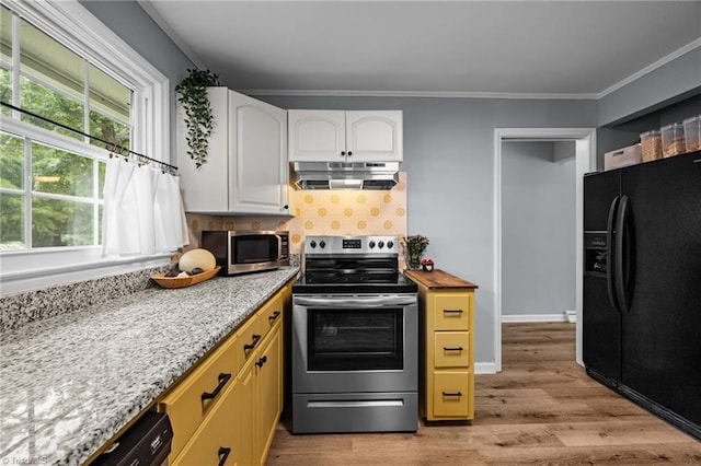 kitchen featuring stainless steel appliances, under cabinet range hood, light wood-type flooring, white cabinetry, and crown molding