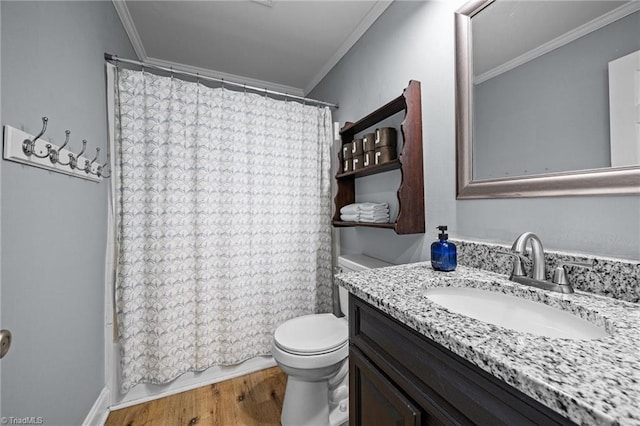 full bathroom featuring ornamental molding, toilet, vanity, wood finished floors, and shower / bath combo