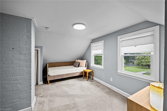 bedroom with vaulted ceiling, baseboards, and carpet