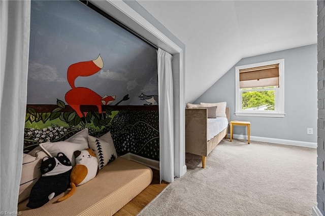 bedroom with vaulted ceiling and baseboards