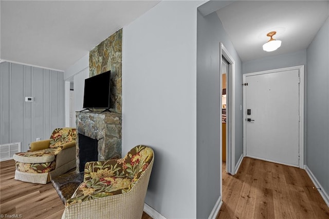 hall featuring wood finished floors and baseboards