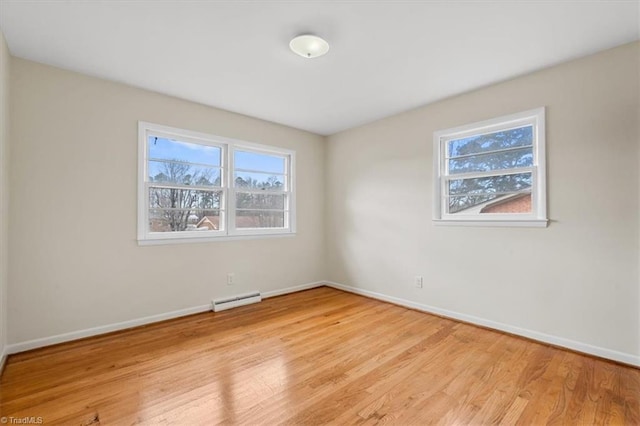 unfurnished room with light hardwood / wood-style floors and a baseboard radiator