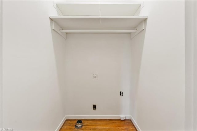 washroom with wood-type flooring and electric dryer hookup