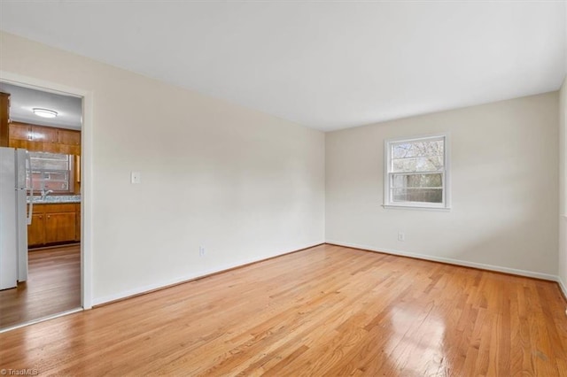 unfurnished room featuring light hardwood / wood-style floors and sink