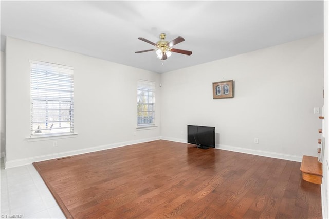 interior space featuring wood-type flooring and ceiling fan