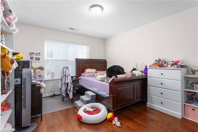 bedroom with dark wood-type flooring