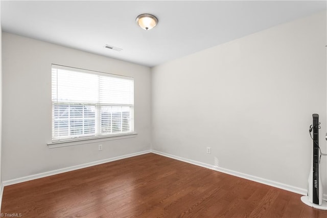 unfurnished room featuring hardwood / wood-style flooring