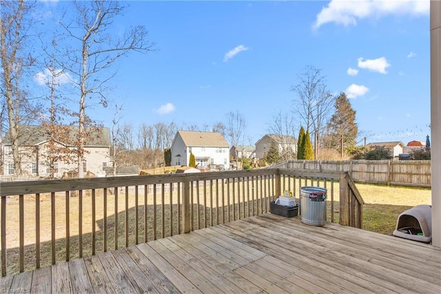 wooden deck featuring a lawn