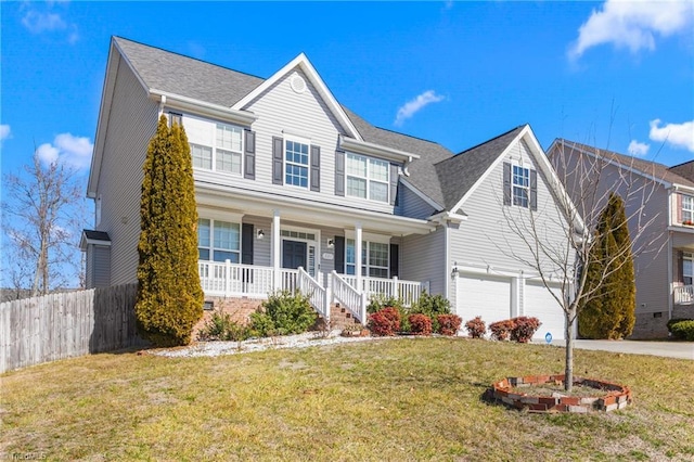 view of front of property with a garage, a front lawn, and covered porch