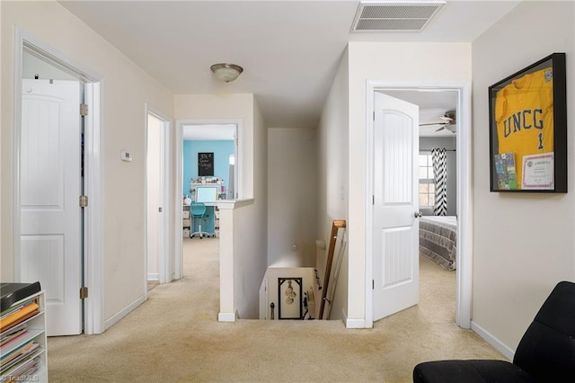 hallway featuring light carpet