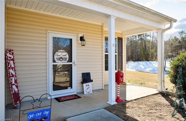 view of exterior entry with a porch