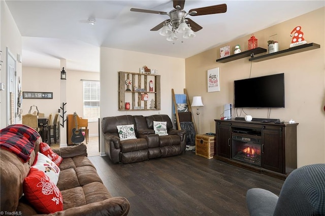 living room featuring dark hardwood / wood-style flooring and ceiling fan