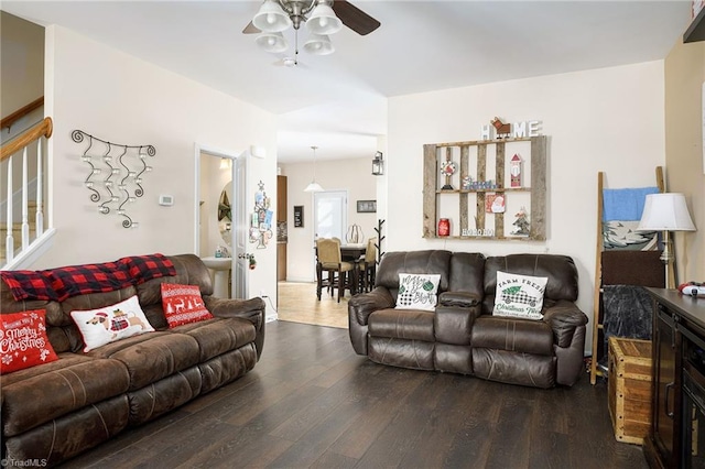 living room featuring hardwood / wood-style flooring and ceiling fan