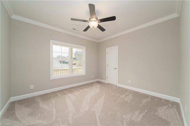 unfurnished room featuring ornamental molding, ceiling fan, and carpet flooring