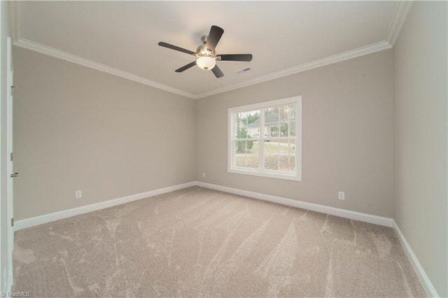 empty room featuring ceiling fan, light colored carpet, and ornamental molding