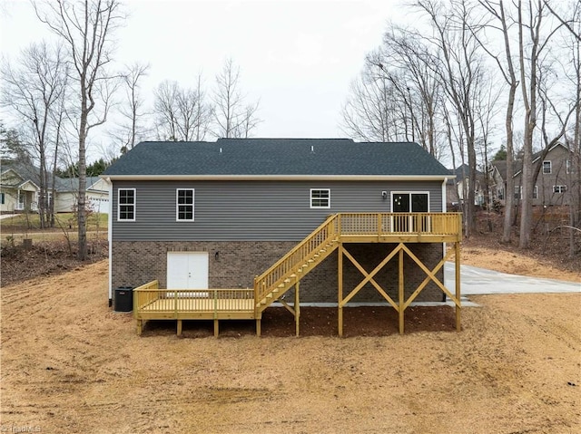 rear view of house featuring a deck