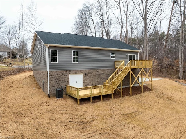 rear view of property with a wooden deck and central air condition unit