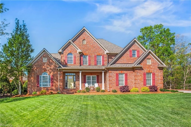 view of front of home with brick siding and a front lawn