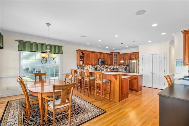 dining area with crown molding, light wood finished floors, a notable chandelier, and recessed lighting