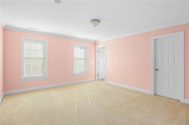 spare room with carpet, baseboards, and ornamental molding