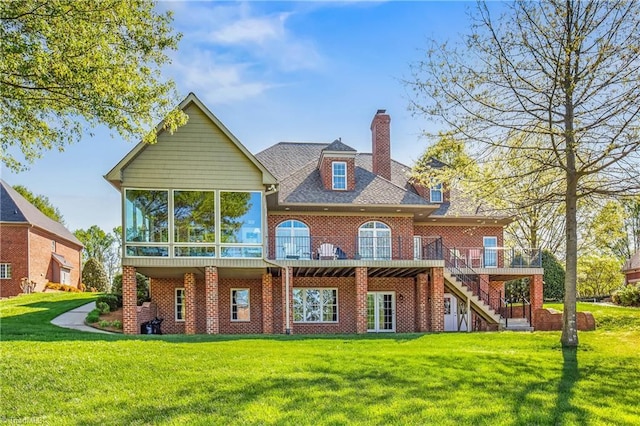 back of house featuring a wooden deck, a sunroom, stairway, brick siding, and a chimney