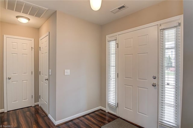 entrance foyer with baseboards, dark wood-style floors, and visible vents