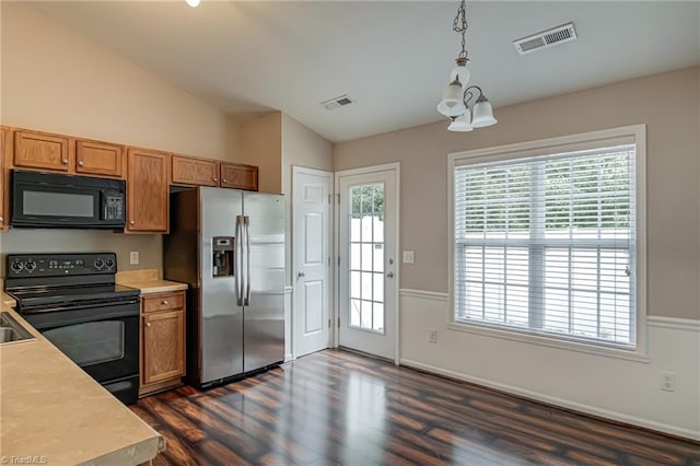 kitchen featuring light countertops, visible vents, lofted ceiling, and black appliances