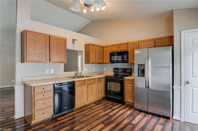 kitchen featuring a sink, light countertops, black appliances, and a notable chandelier
