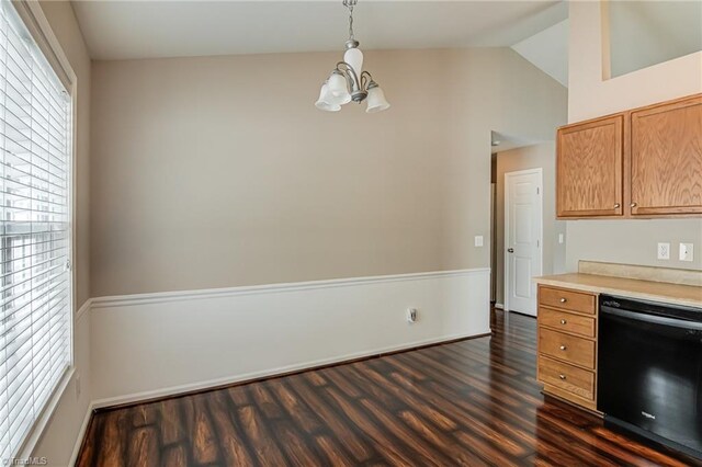 kitchen with lofted ceiling, black dishwasher, light countertops, dark wood finished floors, and a notable chandelier