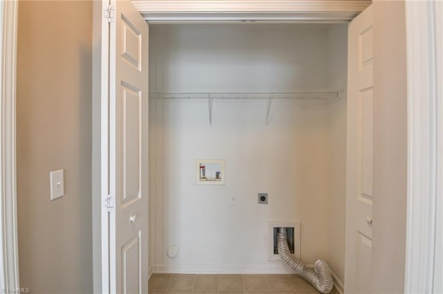 clothes washing area with laundry area, tile patterned flooring, baseboards, electric dryer hookup, and washer hookup