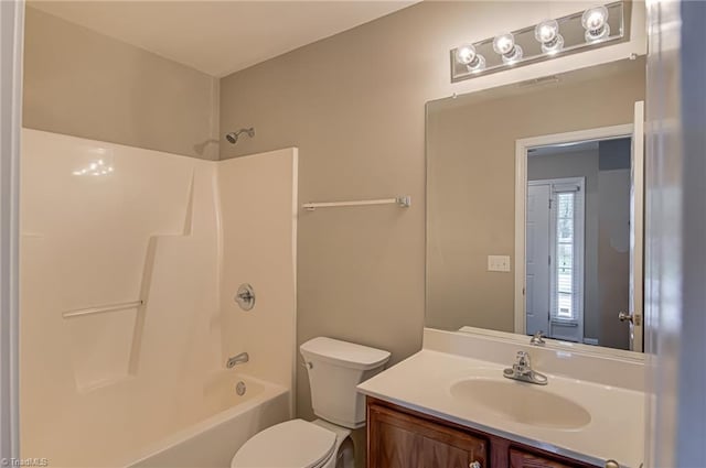 bathroom featuring vanity, toilet, and bathing tub / shower combination