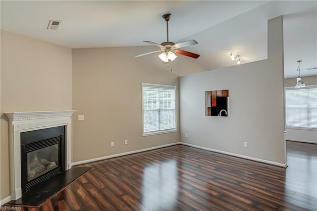 unfurnished living room featuring visible vents, plenty of natural light, wood finished floors, and vaulted ceiling