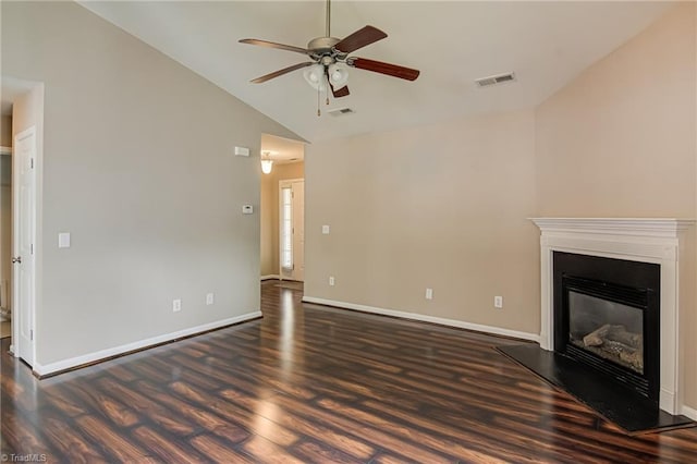 unfurnished living room with a glass covered fireplace, ceiling fan, visible vents, and dark wood-type flooring
