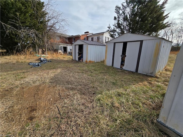 view of yard featuring a shed and an outbuilding