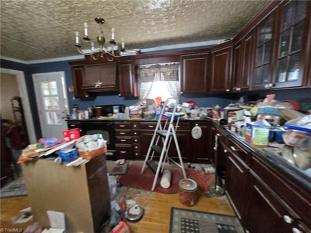 kitchen with an ornate ceiling, dark countertops, ornamental molding, and dark brown cabinetry