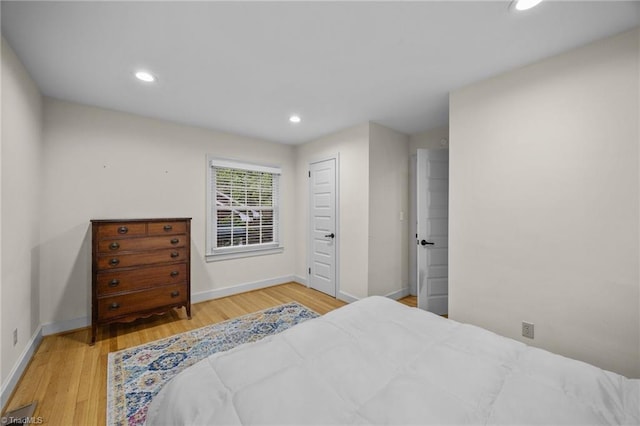 bedroom with baseboards, recessed lighting, and wood finished floors